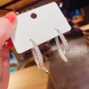 Curved S Cross Korean Earrings - Image 5